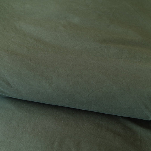 Folded olive-colored duvet cover showing the fabric texture and natural wrinkles.
