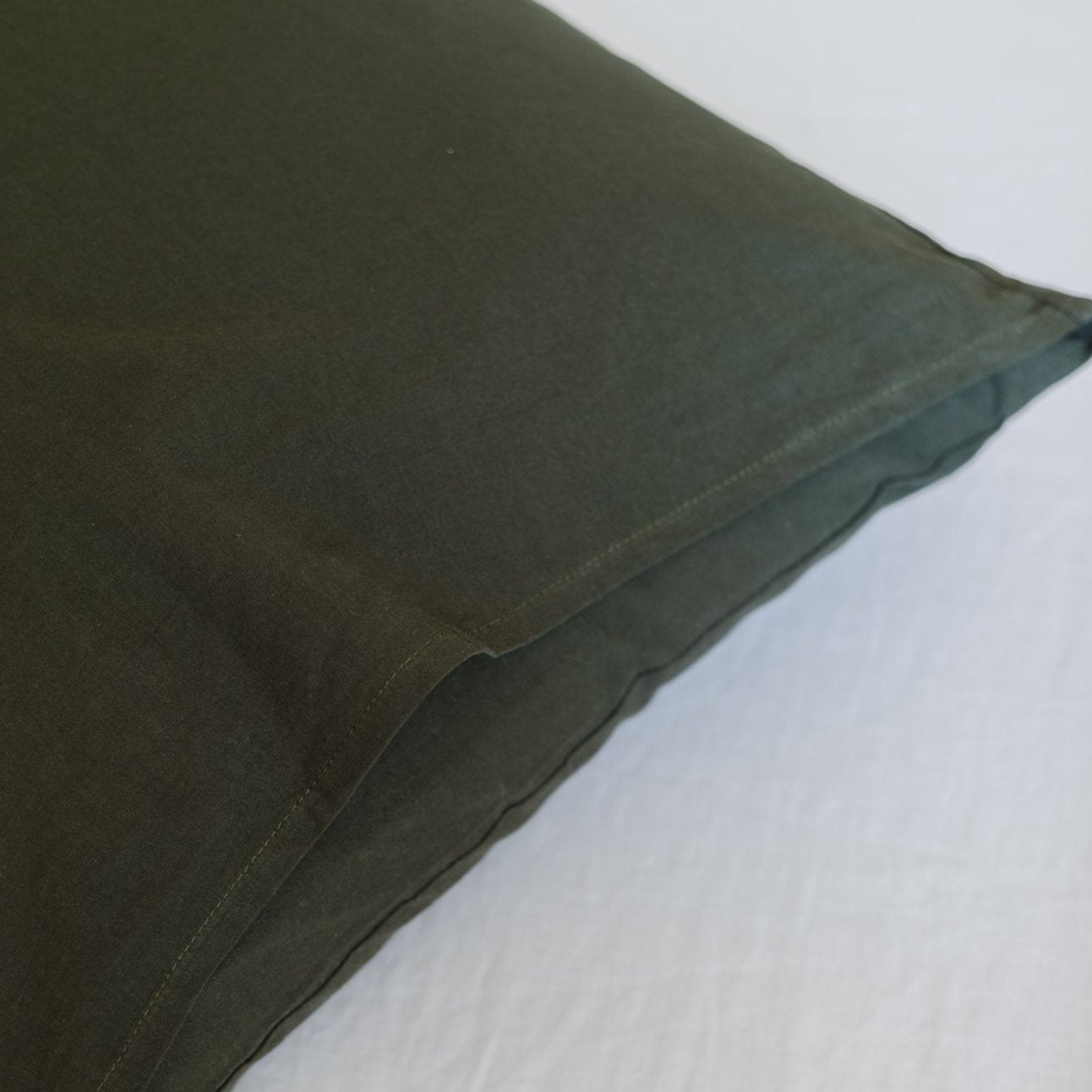 Olive-green duvet cover with visible seam detail and soft fabric texture.