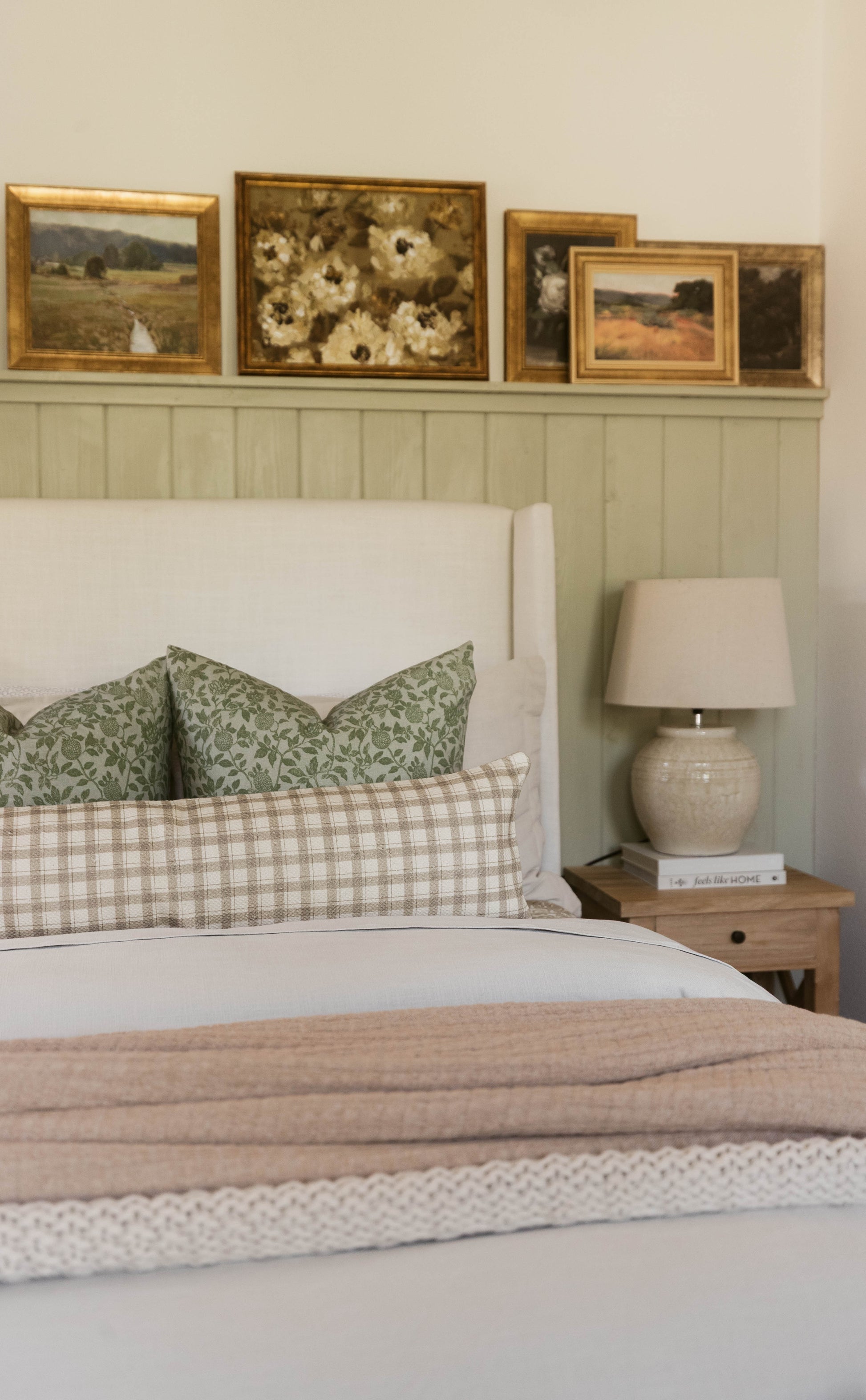 Beige and cream cotton throw blanket with thick weave texture displayed folded on a bed.