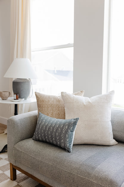 Sage Leaves lumbar pillow with leaf pattern in gray-blue on gray upholstered sofa with coordinating pillows.