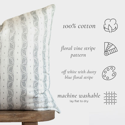 Cream lumbar pillow with dusty blue vertical floral vine stripe pattern, 100% cotton.