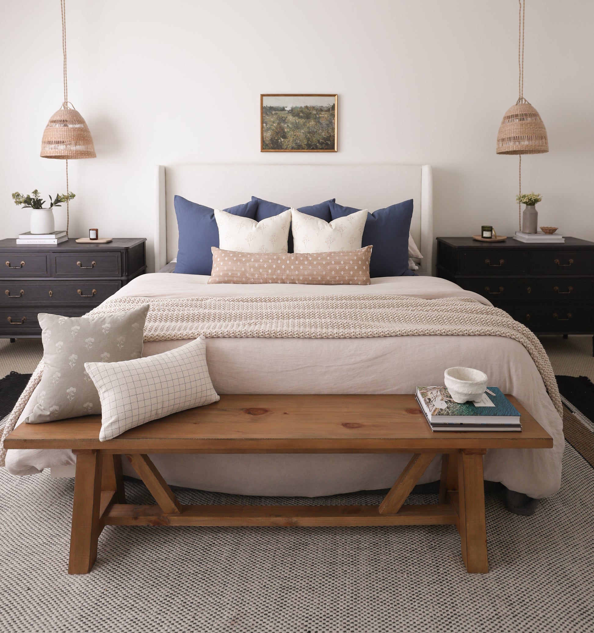 Woven pendant light with natural fiber dome shade and rope suspension in bedroom setting.