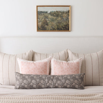Framed landscape artwork with gold-toned border depicting a scenic hillside with trees and sky.