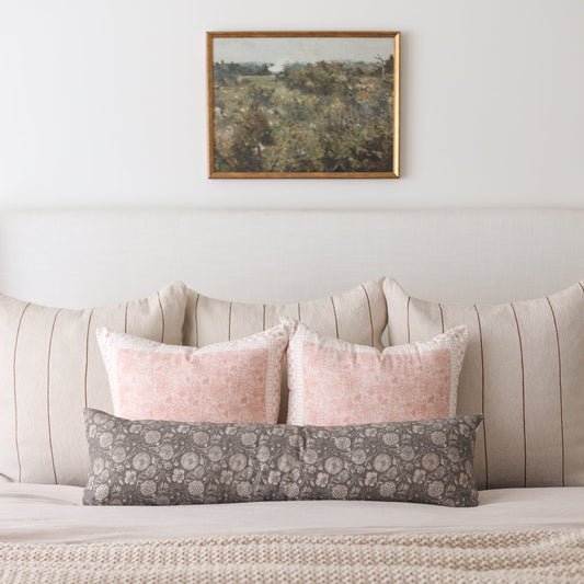 Framed landscape artwork with gold-toned border depicting a scenic hillside with trees and sky.