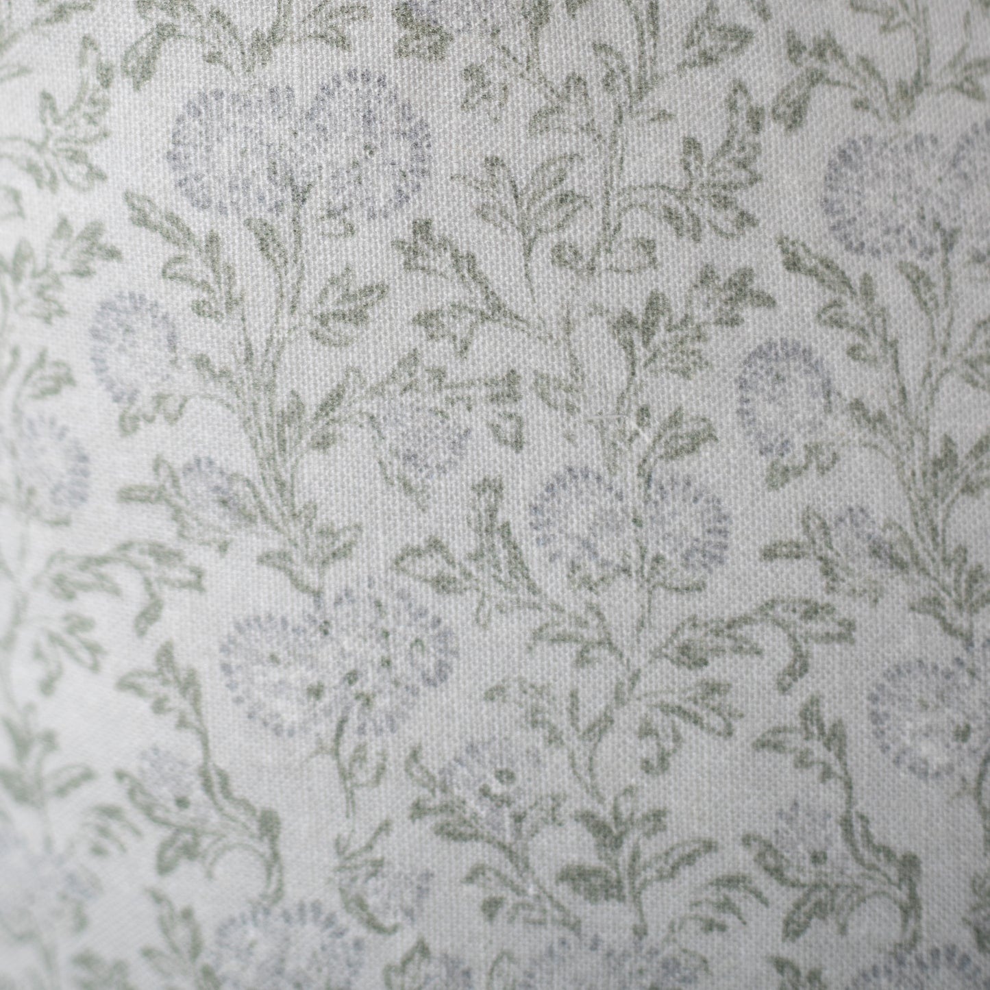 Cream linen fabric with scattered sage green leaf pattern throughout.