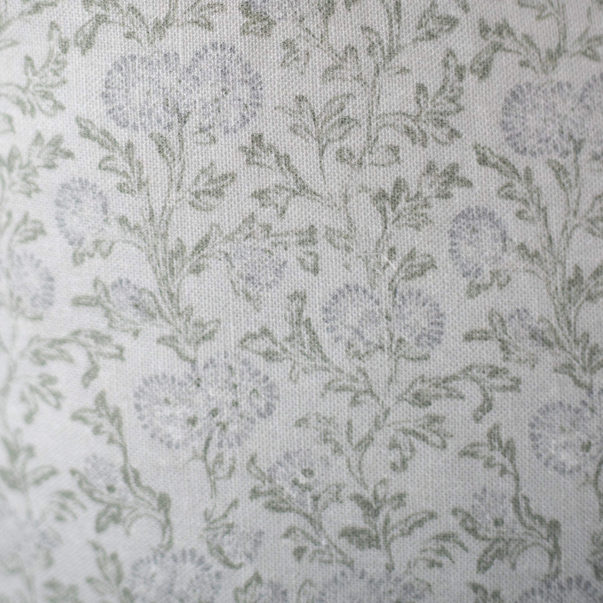 Cream linen fabric with scattered sage green leaf pattern throughout.