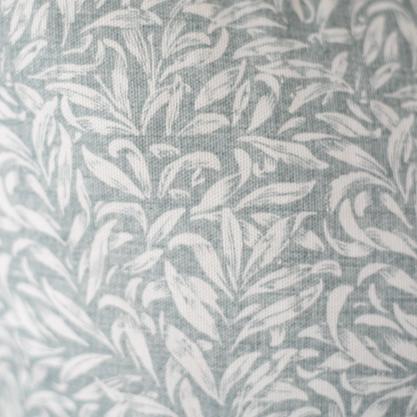 Gray and white leafy damask pattern on woven textile fabric.