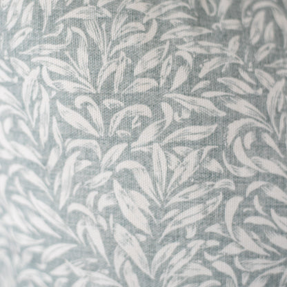 Gray and white leafy damask pattern on woven textile fabric.