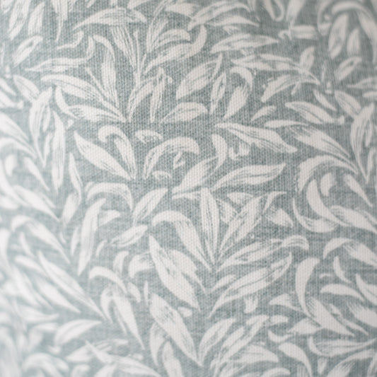 Gray and white leafy damask pattern on woven textile fabric.