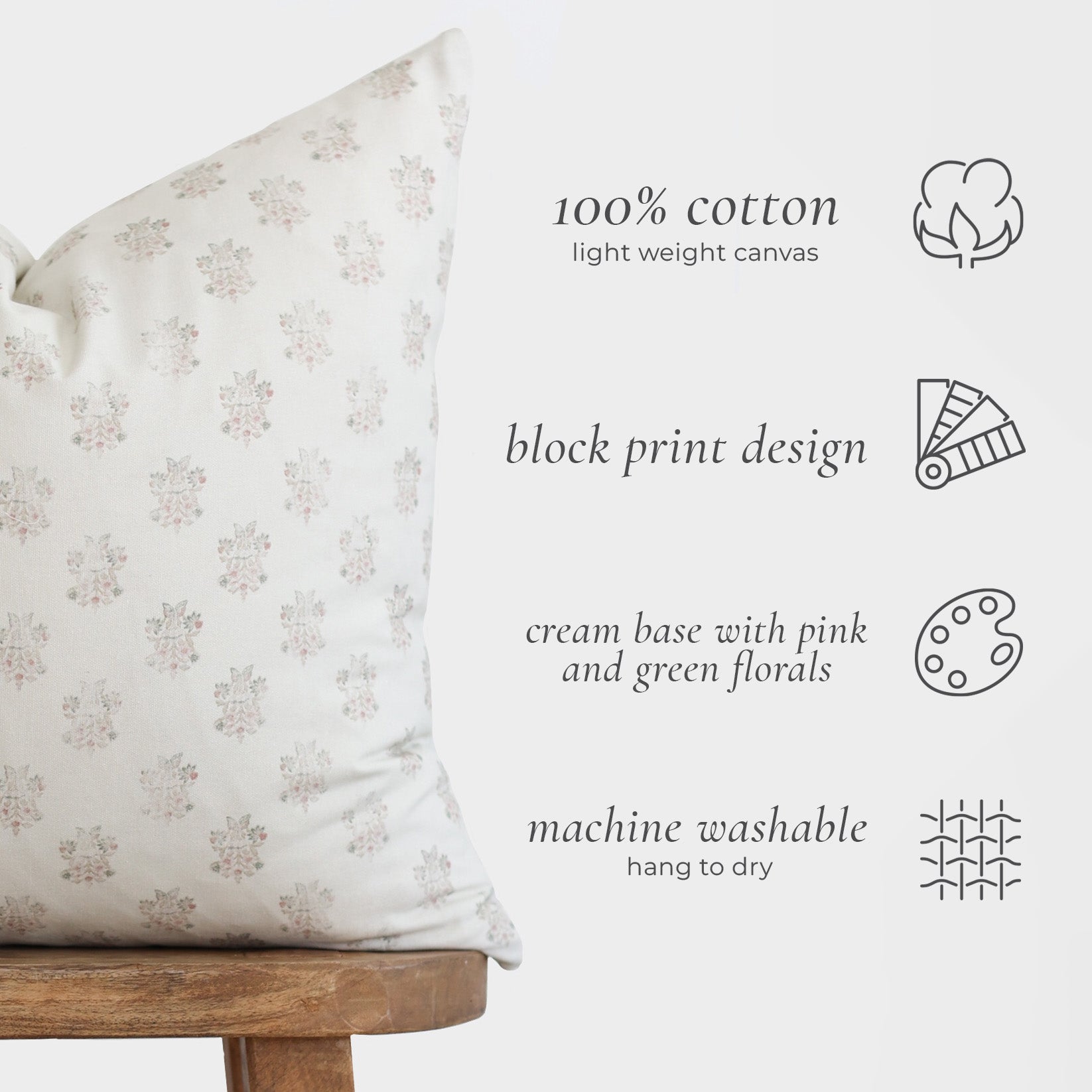 Cream canvas pillow with small pink and green floral block print pattern throughout.