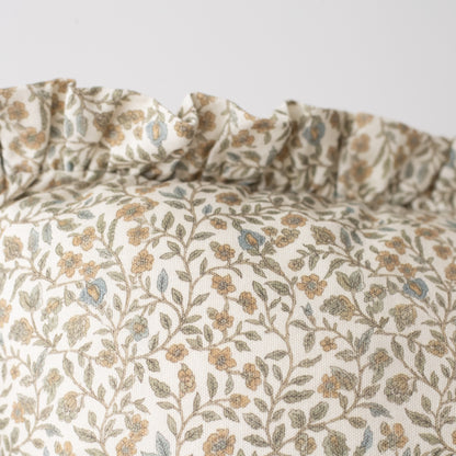 Cream linen pillow with ruffled edge and tan and green floral botanical print.