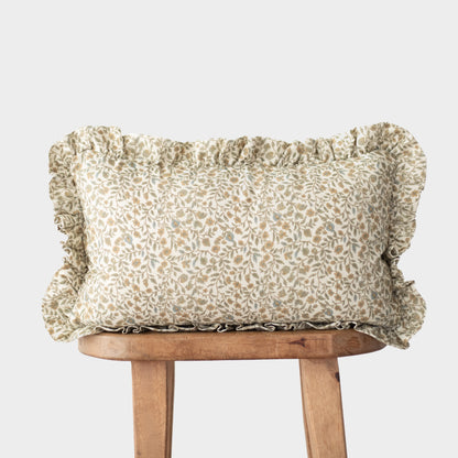 Rectangular pillow with ruffled edges in cream and tan leaf pattern, displayed on wooden chair.