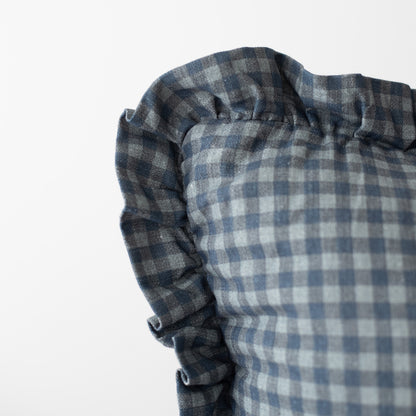 Navy gingham pillowcase with ruffled edges in blue and white checked pattern.