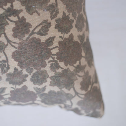 Lumbar pillow with taupe and cream floral damask pattern on woven fabric.