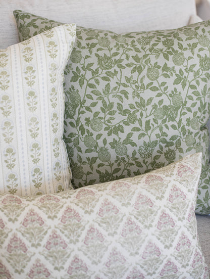 Five decorative pillows with green botanical and pink floral patterns in varying sizes.