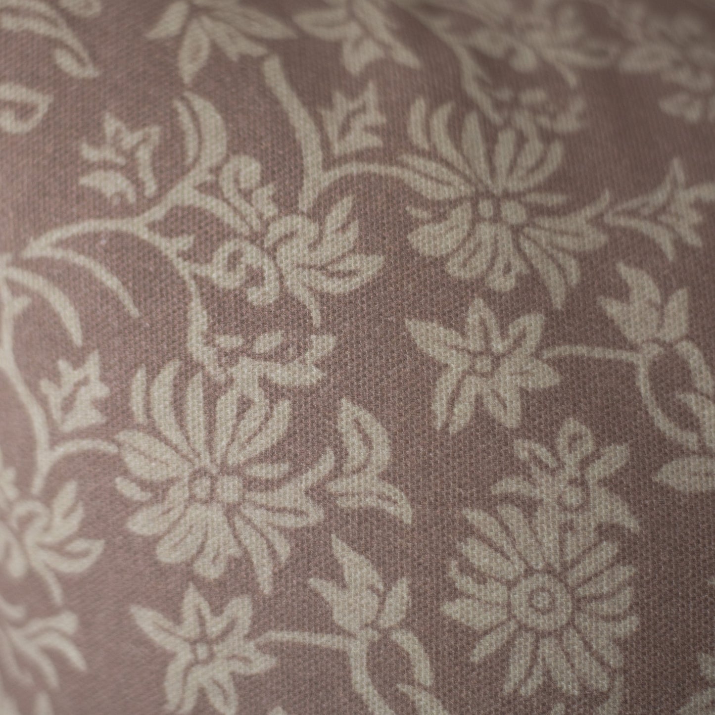 Taupe damask patterned fabric with cream floral motifs on textured woven material.