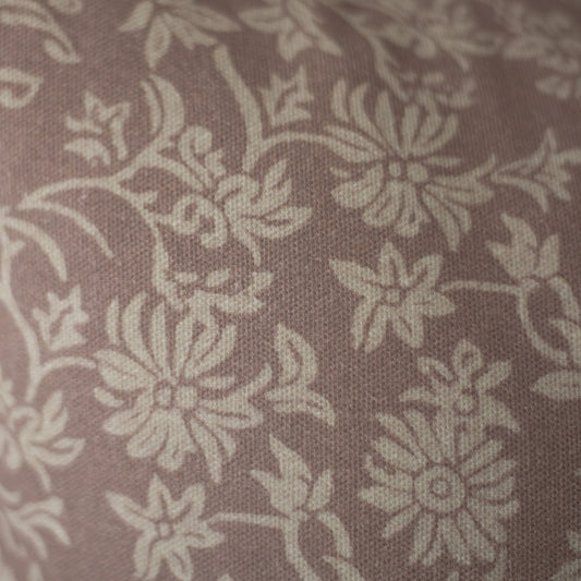 Taupe fabric with cream damask floral pattern and textured weave.