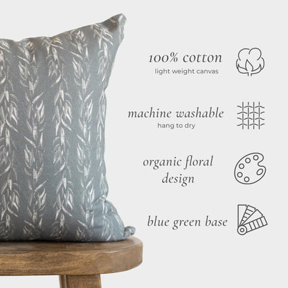 Sage-colored cotton canvas pillow with vertical leaf pattern on wooden stool, 18" x 20".
