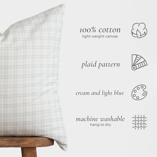 Cream and light blue plaid cotton pillow cover on wooden chair with product details.
