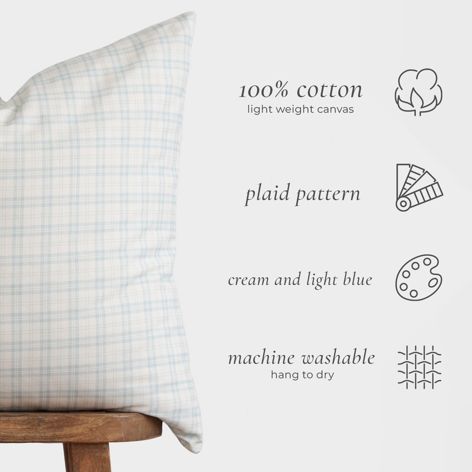 Cream and light blue plaid lumbar pillow with cotton canvas cover displayed on wooden chair.