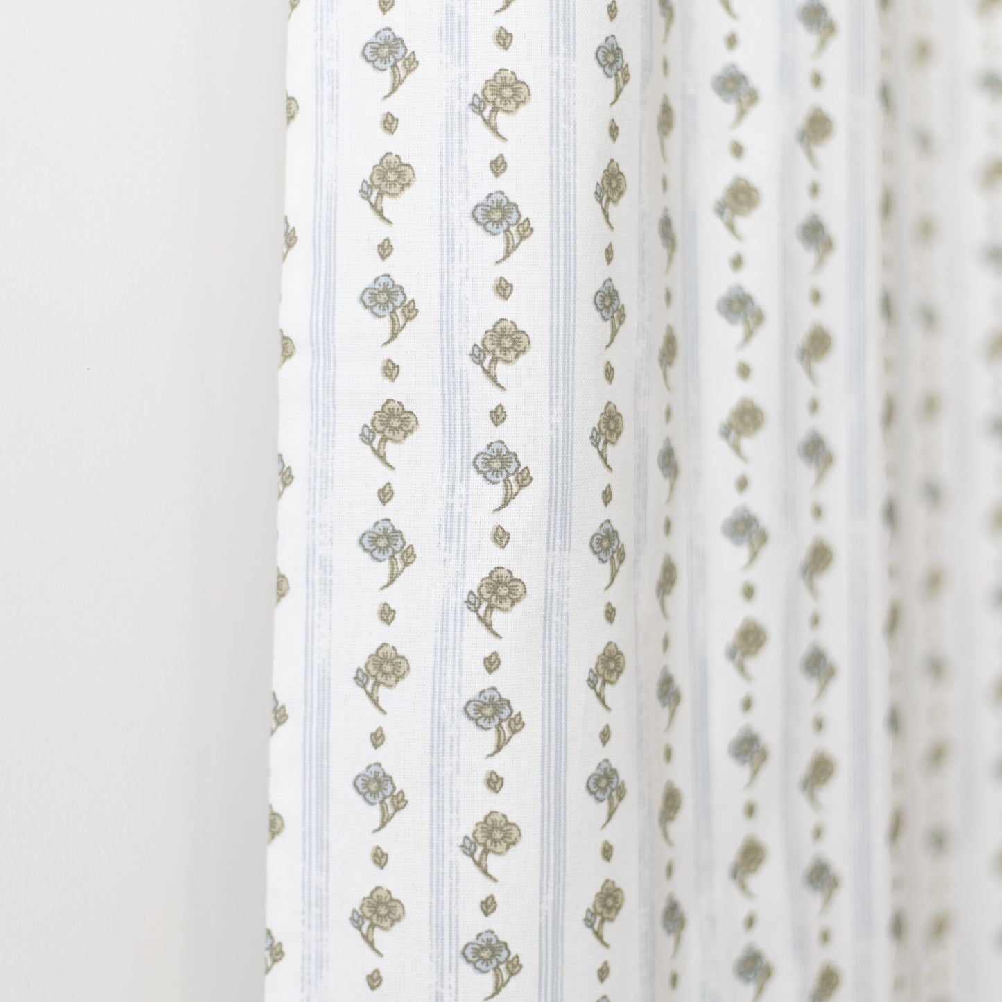 White curtain panel with vertical stripes and gold floral bouquet pattern throughout.