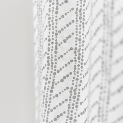 White curtain panel with gray dotted diagonal stripe pattern and textured weave.