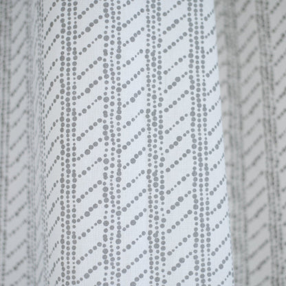 White shower curtain with gray diagonal dotted stripe pattern.