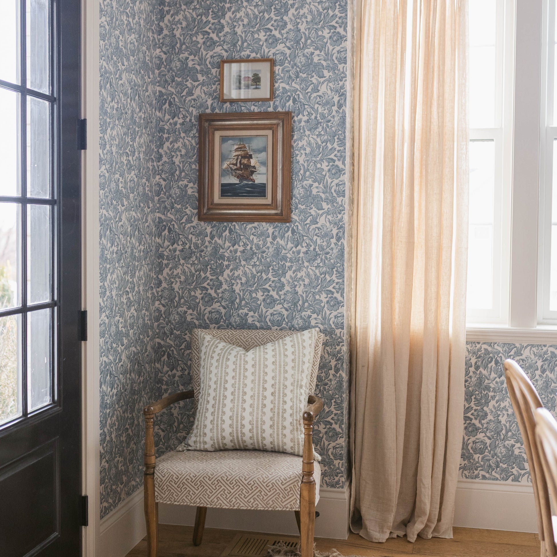 Double-sided linen pillow with cream and beige geometric striped pattern, displayed on wooden chair.