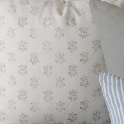 Cream fabric with small repeating floral damask pattern in pink and gray tones.