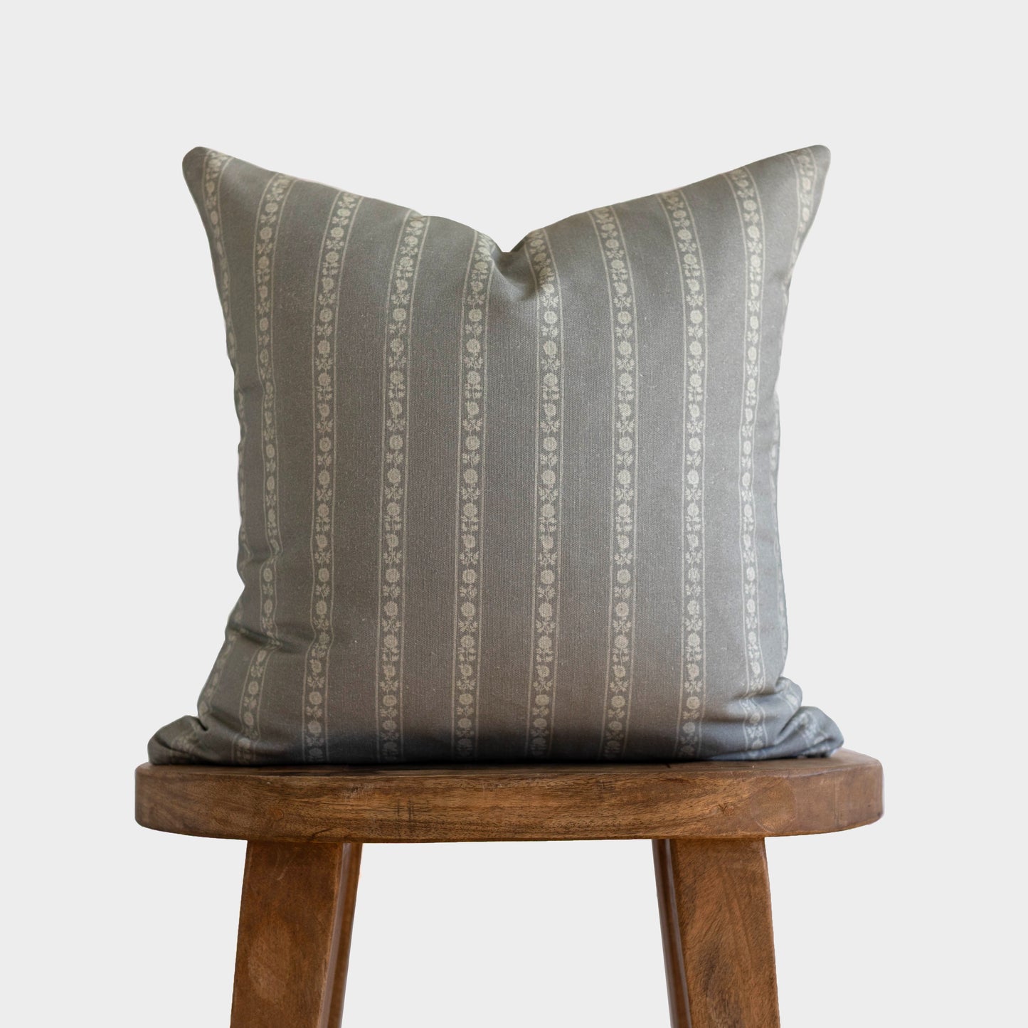 Gray and cream striped double-sided pillow with decorative ornamental pattern, 18" x 22".