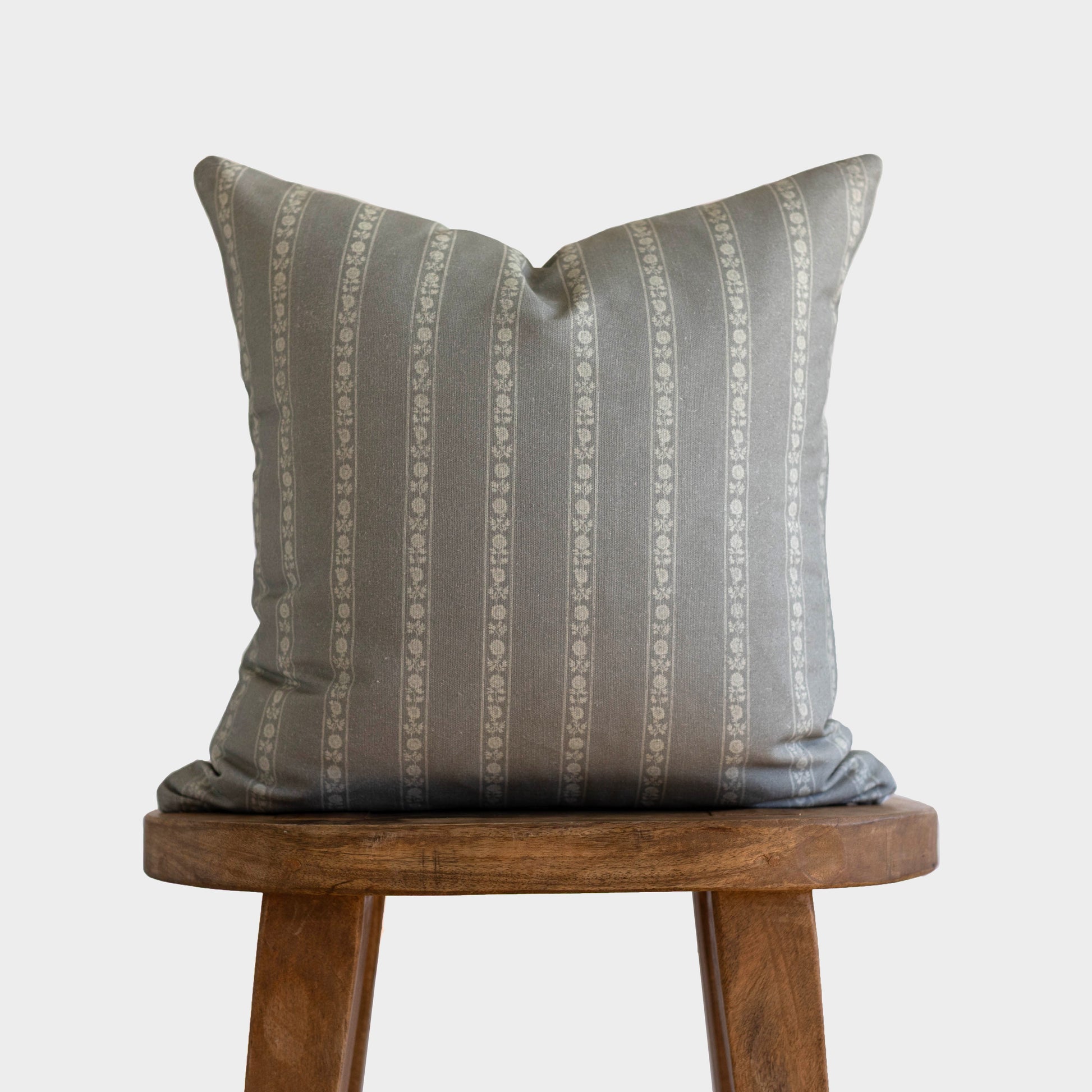 Gray and cream striped double-sided pillow with decorative ornamental pattern, 18" x 22".