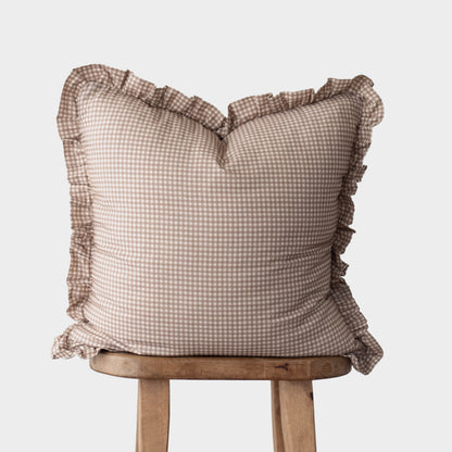 Tan and white mini gingham square pillow with ruffled edges on all sides.