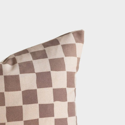 Tan and brown checkered pillow cover with alternating square pattern.