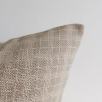 Taupe linen pillow cover with white window pane pattern visible on corner detail.