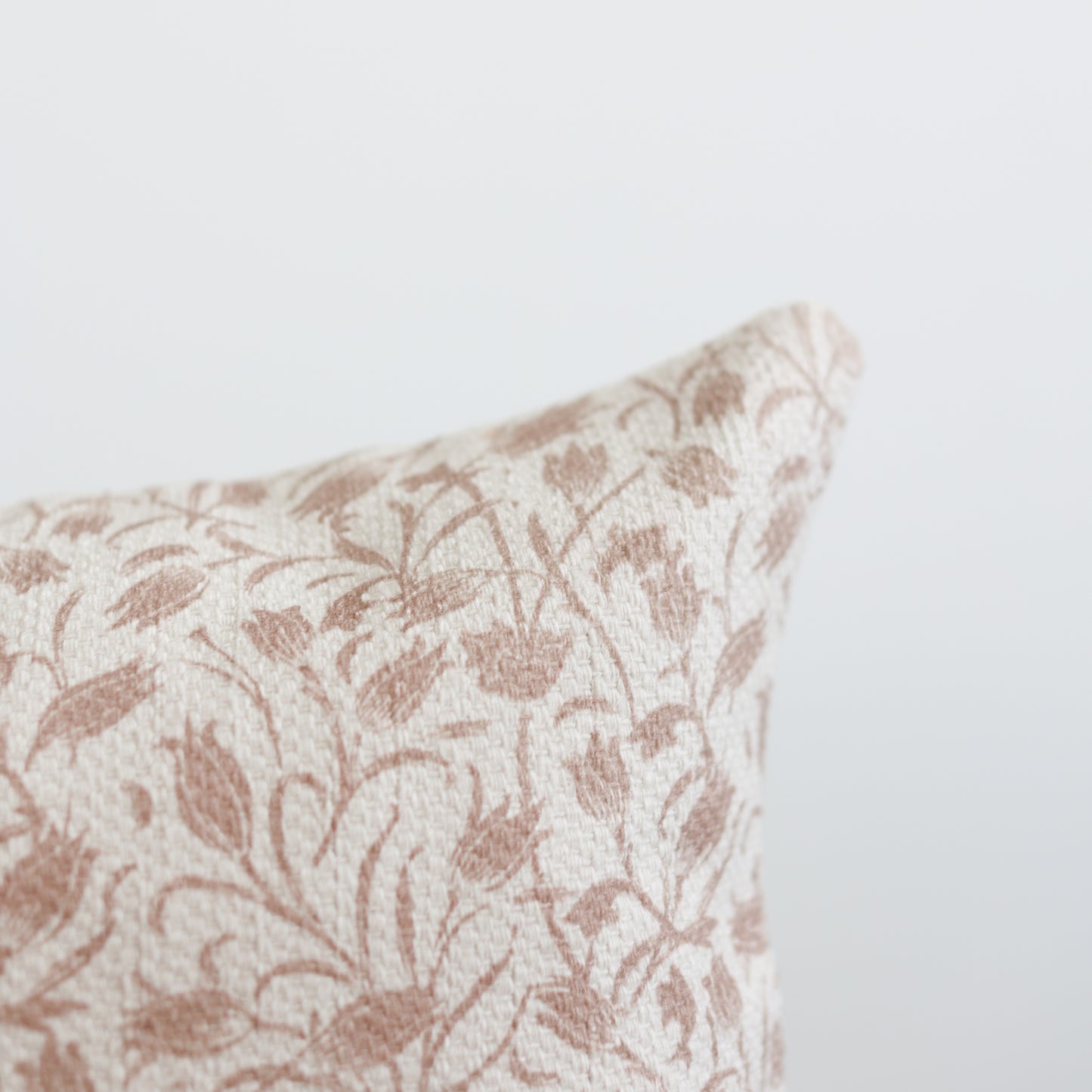 Rectangular pillow with cream and tan damask leaf pattern, textured weave fabric.