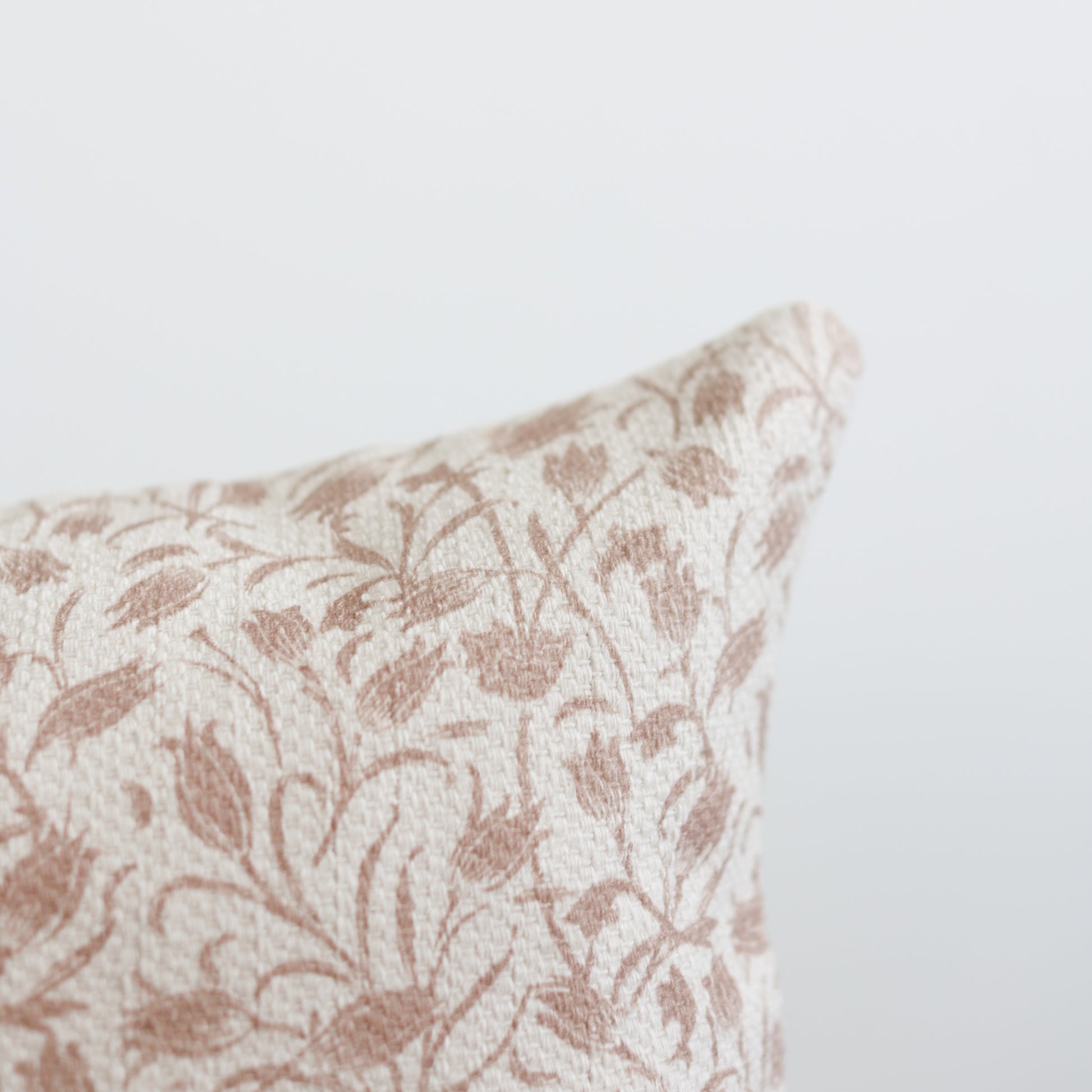 Rectangular pillow with cream and tan damask leaf pattern, textured weave fabric.