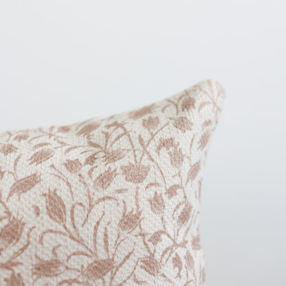 Beige and cream decorative pillow with tan floral damask pattern and textured weave.