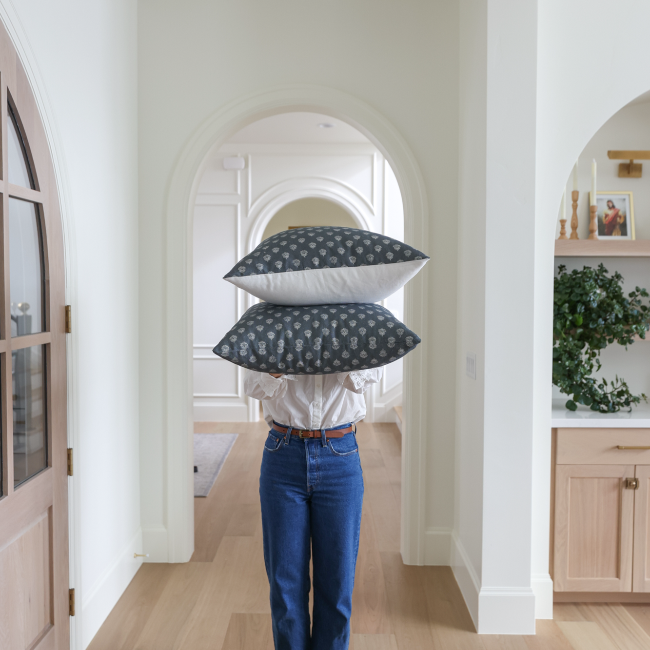 Two stacked rectangular pillows with dark blue and white dotted pattern displayed in a hallway.