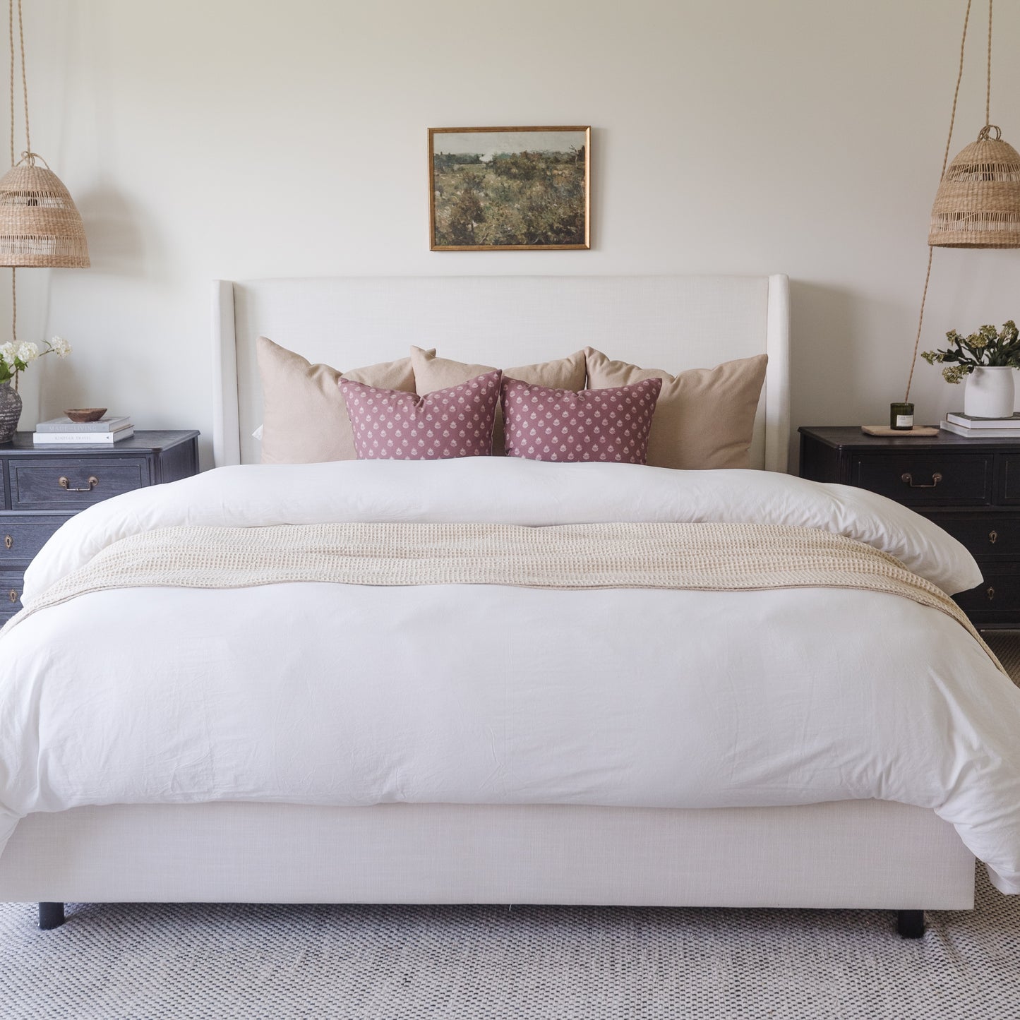 White duvet cover on king-size bed with matching pillowcases and decorative pillows in bedroom setting.
