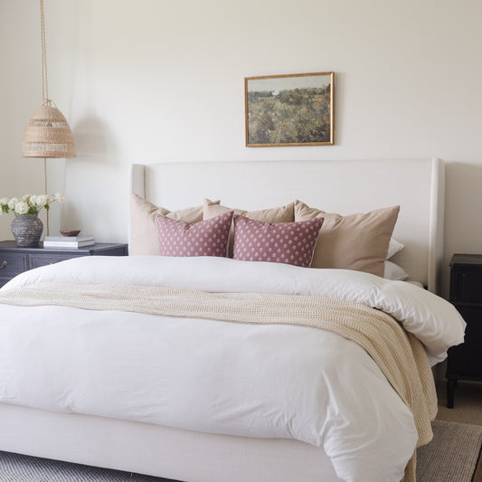 White duvet cover set on king bed with coordinating pillows and throw blanket.
