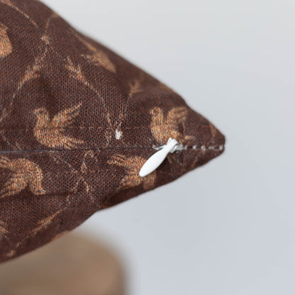 Brown decorative pillow with tan damask pattern and white zipper closure.