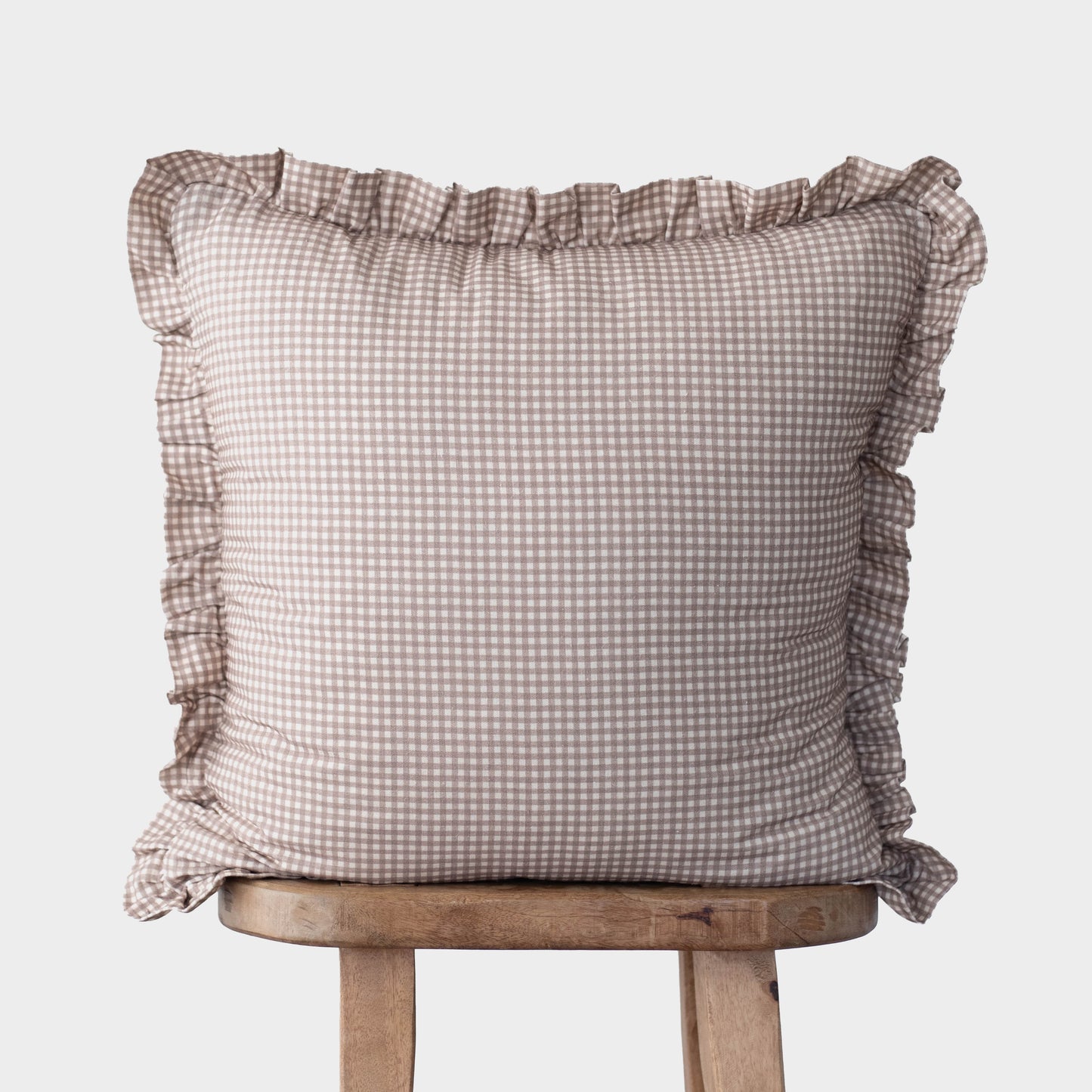 Tan and white mini gingham pillow cover with ruffled edges on all sides.