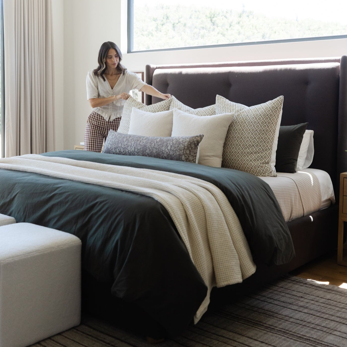 Gretta lumbar pillow with geometric pattern displayed on bed with coordinating bedding and decorative pillows.