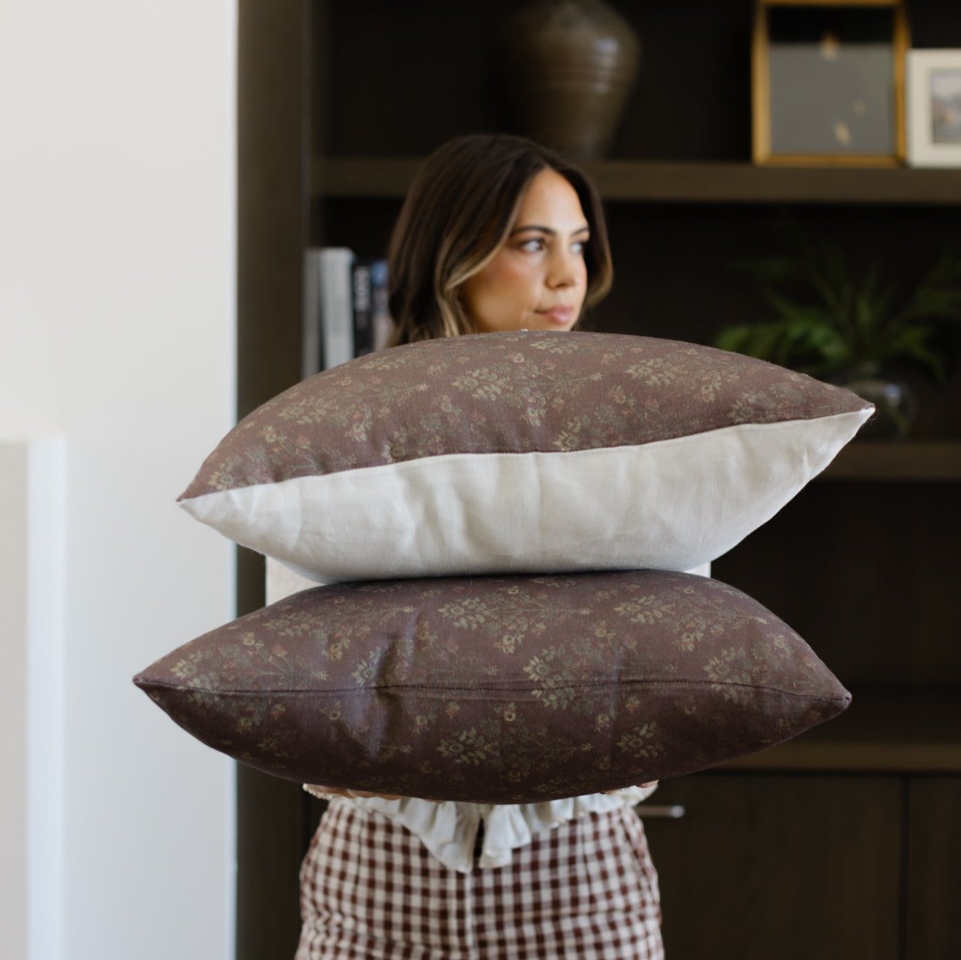 Bordeaux linen pillows with floral pattern and cream back panel in stacked display.