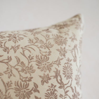 Cream rectangular pillow with tan floral and leaf pattern throughout.