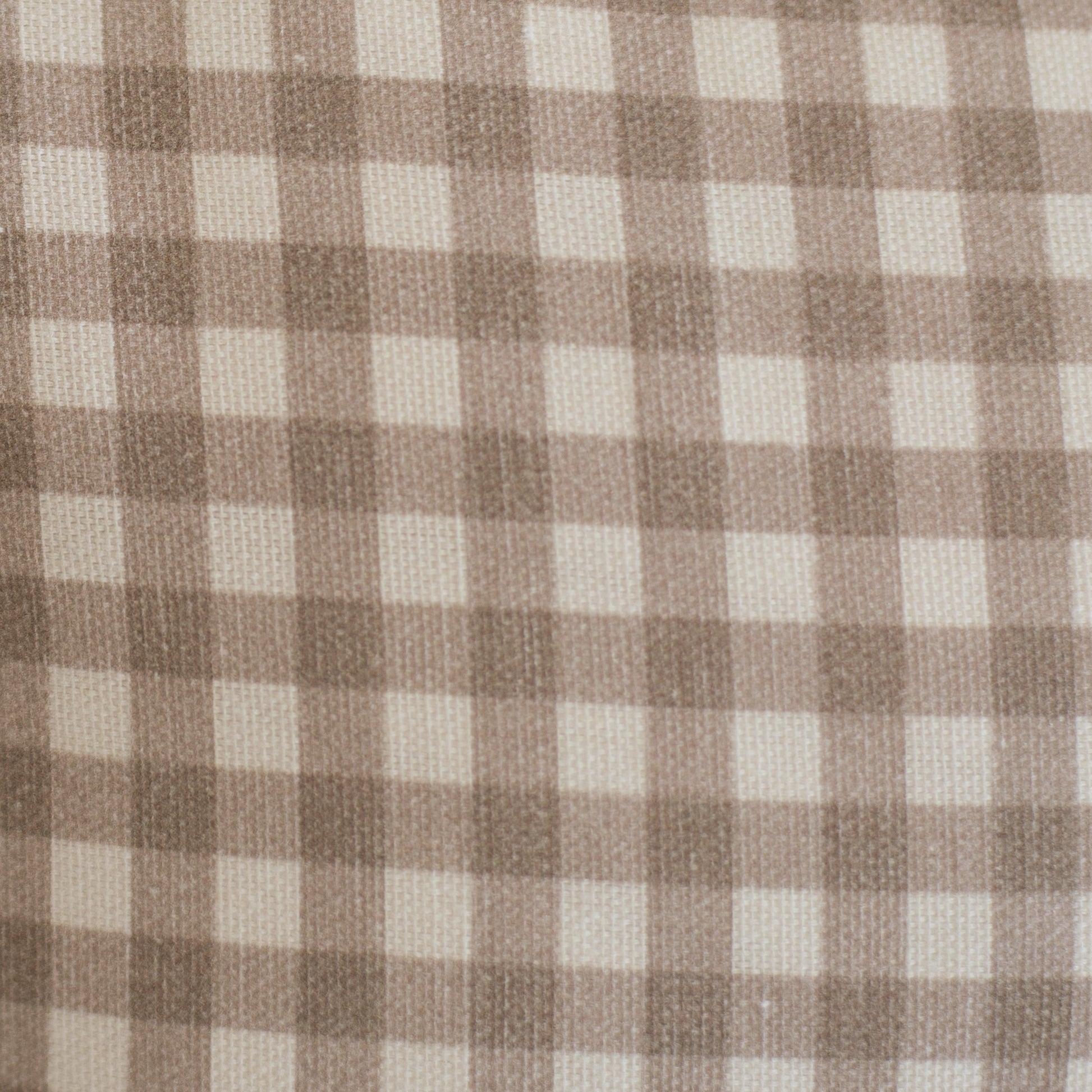 Tan and cream gingham check fabric with evenly spaced squares in a woven texture.