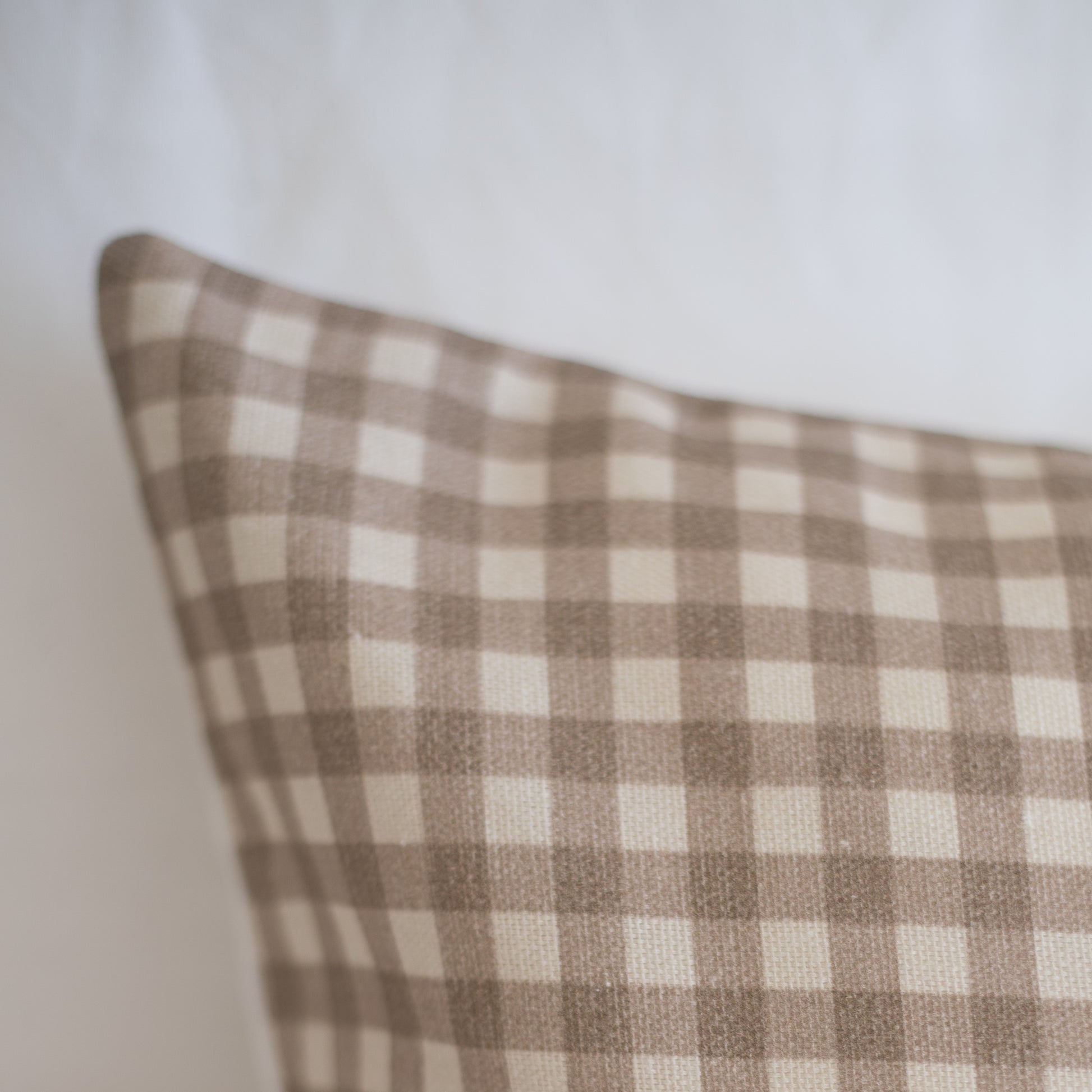 Tan and cream gingham check lumbar pillow cover with woven texture.