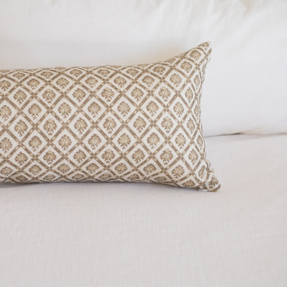Rectangular linen lumbar pillow with beige and cream diamond pattern containing small floral motifs.