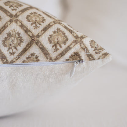 Linen lumbar pillow with tan and cream geometric damask pattern and white zipper closure.