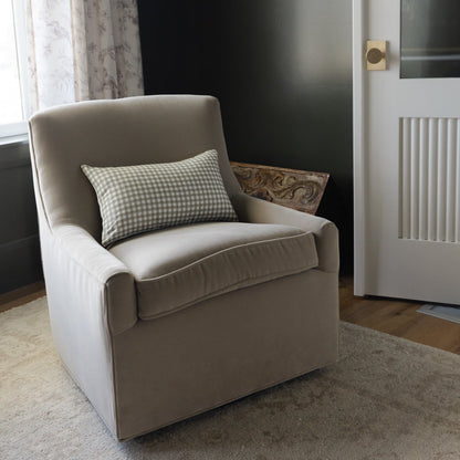 Green and white gingham lumbar pillow displayed on a beige upholstered armchair.